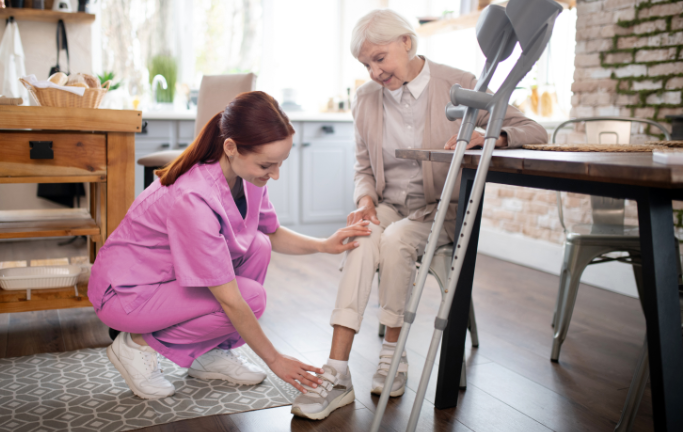 Nurse of life therapy caring for elderly woman at home 